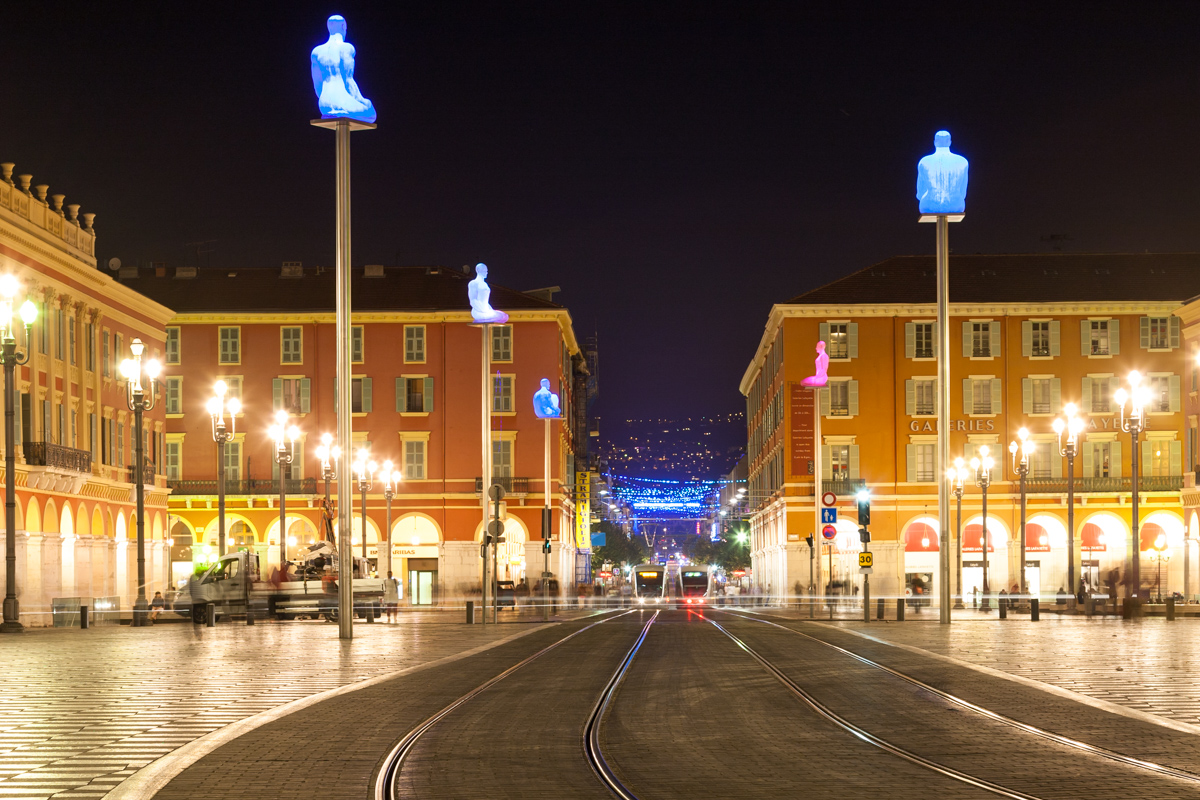 Place Masséna showing art installation of giant glowing buddhas on plinths by Jaume Plensa