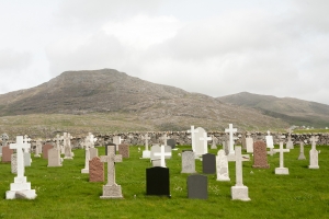 Barra cemetery showing the graves facing the land, the drystone wall and the background hills