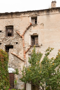 Side shot of Corte apartment showing some rustic plumbing.